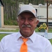 A man in white shirt and orange tie